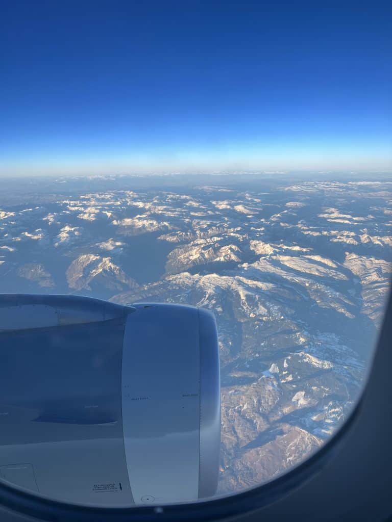 Airplane window mountains and snow